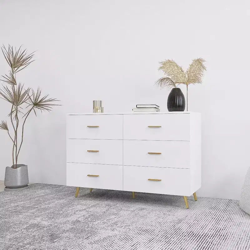 Commode à 6 tiroirs Okak avec poignées dorées et pieds en acier, grands tiroirs spacieux, meuble de rangement élégant pour l'organisation de la maison