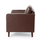 Fauteuil club capitonné contemporain en similicuir GDFStudio Hixon avec traversins
