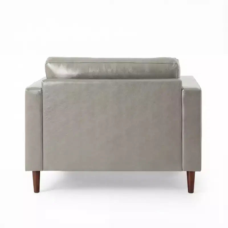 Fauteuil club capitonné contemporain en similicuir GDFStudio Hixon avec traversins