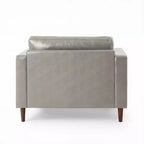 Fauteuil club capitonné contemporain en similicuir GDFStudio Hixon avec traversins