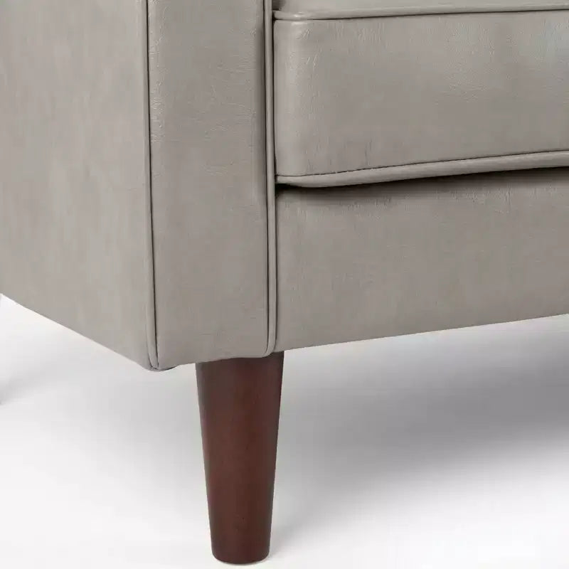 Fauteuil club capitonné contemporain en similicuir GDFStudio Hixon avec traversins