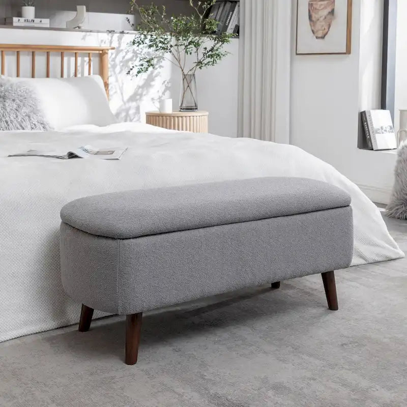 Banc de rangement Celia en tissu bouclé avec pieds en bois d'hévéa