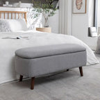 Banc de rangement Celia en tissu bouclé avec pieds en bois d'hévéa