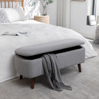 Banc de rangement Celia en tissu bouclé avec pieds en bois d'hévéa