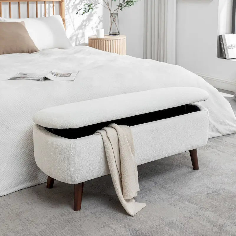 Banc de rangement Celia en tissu bouclé avec pieds en bois d'hévéa